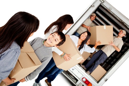 Packed student belongings including books, clothes, and bedding in storage