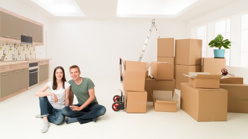 A family settling into a new home after house removals in Perivale